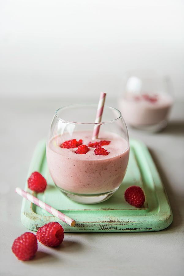 A Glass Of Raspberry Drinking Yoghurt With Fresh Raspberries Photograph by Magdalena Hendey