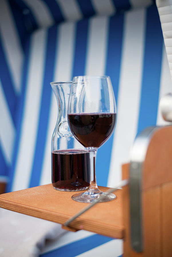 A Glass Of Red Wine And A Carafe Of Wine In A Beach Chair Photograph by Jelena Filipinski