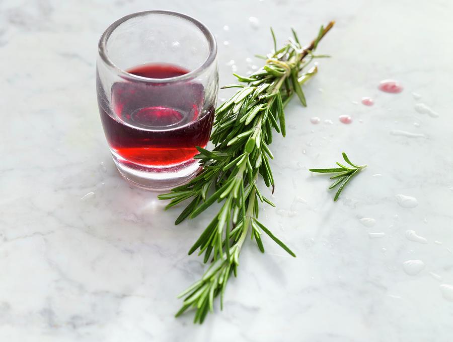 A Glass Of Red Wine And A Sprig Of Rosemary Photograph by Linda Sonntag