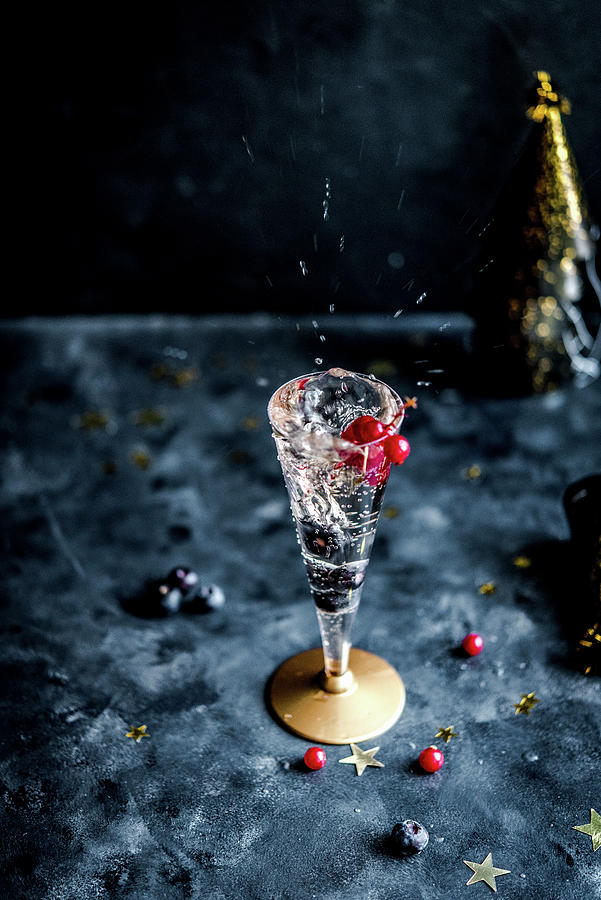A Glass Of Sparkling Champagne With Blueberries And Redcurrants Photograph by Diana Kowalczyk