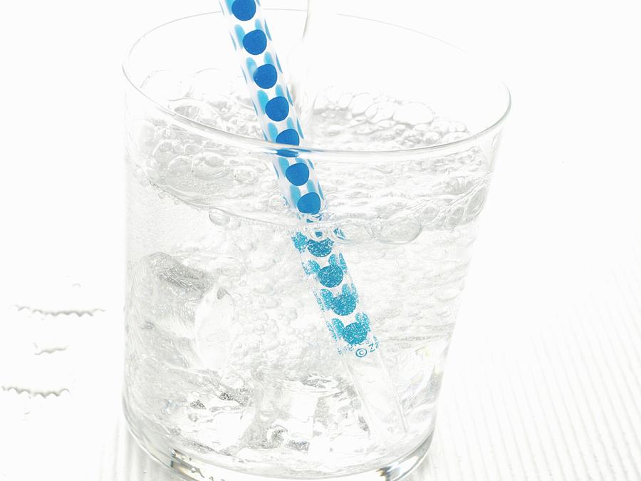 A Glass Of Sparkling Mineral Water With Ice Cubes And A Straw Photograph by Frank Adam