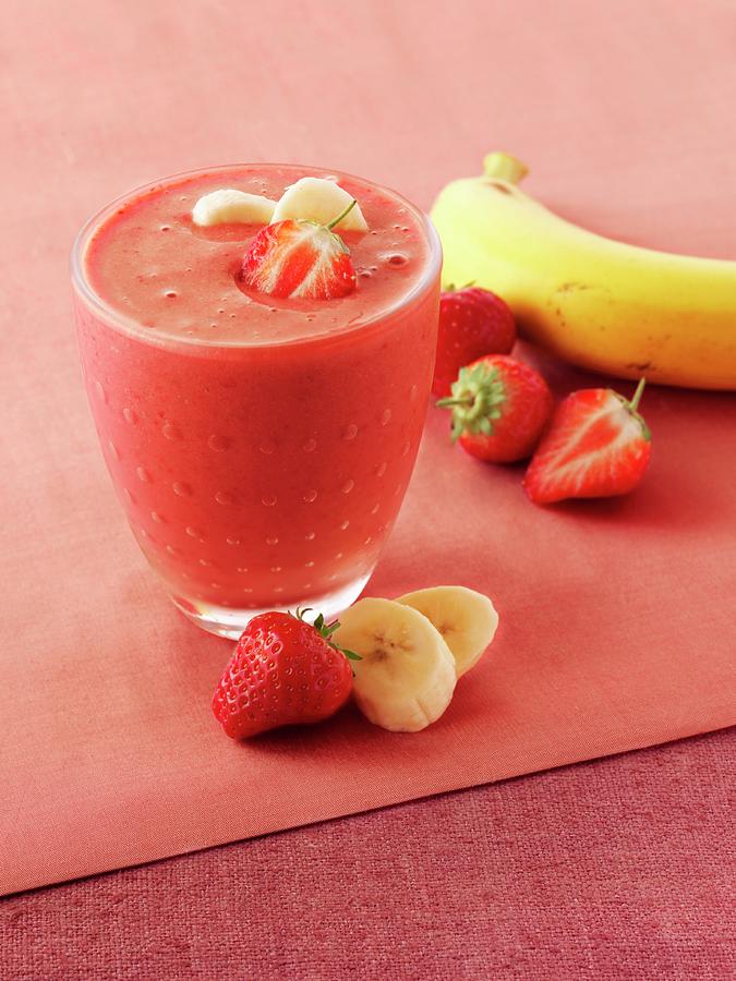 A Glass Of Strawberry And Banana Smoothie Photograph by Frank Adam