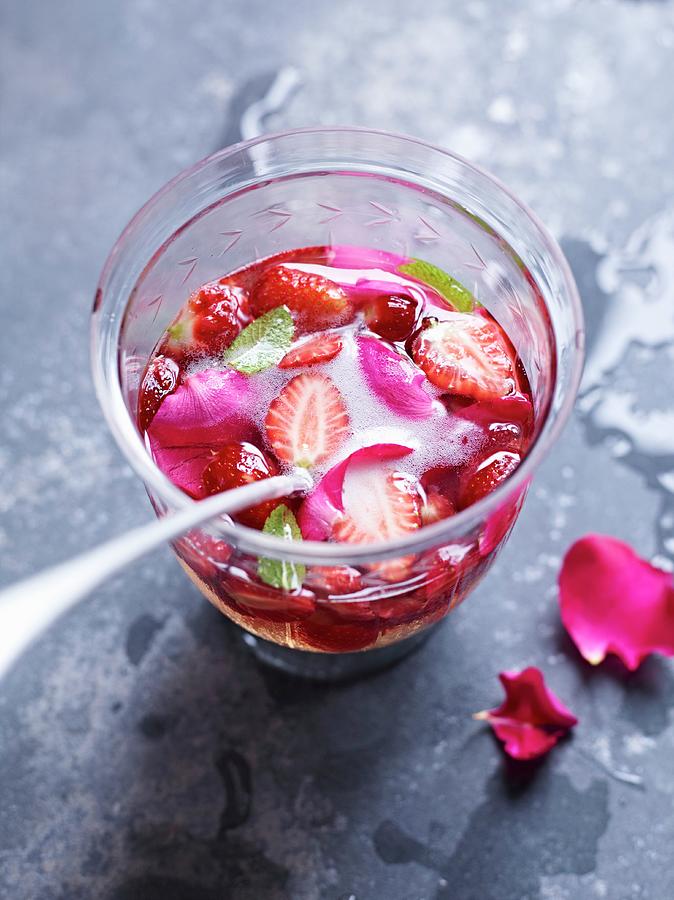 A Glass Of Strawberry Punch With Rose Petals Photograph by Oliver Brachat