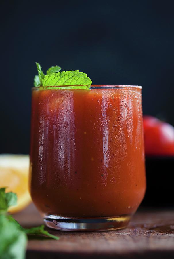 A Glass Of Tomato And Orange Juice With Fresh Mint Photograph by Nandita Shyam Sunder