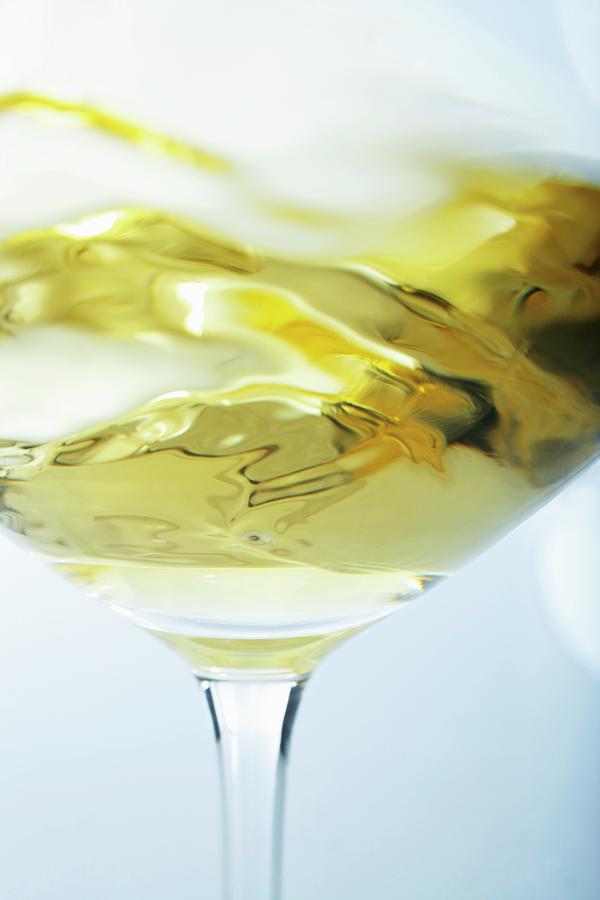 A Glass Of White Wine Being Swirled Photograph by Jalag / Gtz Wrage
