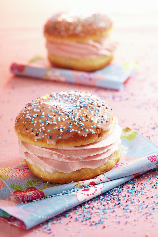 A Glazed Carnival Doughnut Filled With Raspberry Cream Photograph by Teubner Foodfoto