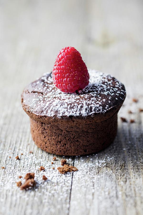 A Gluten-free Chocolate Muffin Decorated With A Raspberry Photograph by Jan Wischnewski