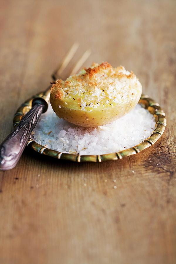 A Gratinated Baked Potato On A Bed Of Salt Photograph by Michael Wissing