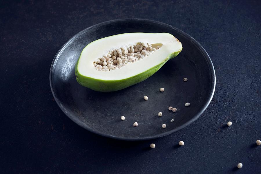 A Green Papaya On A Plate Photograph by Kati Neudert