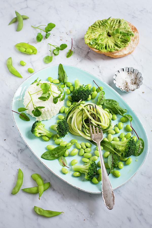 A Green Salad Made Of Courgette Spaghetti, Edamame Beans, Broccoli, Water Cress, Bloodwort, Baby Spinach With Ricotta, Avocado Bagel Photograph by Tina Engel