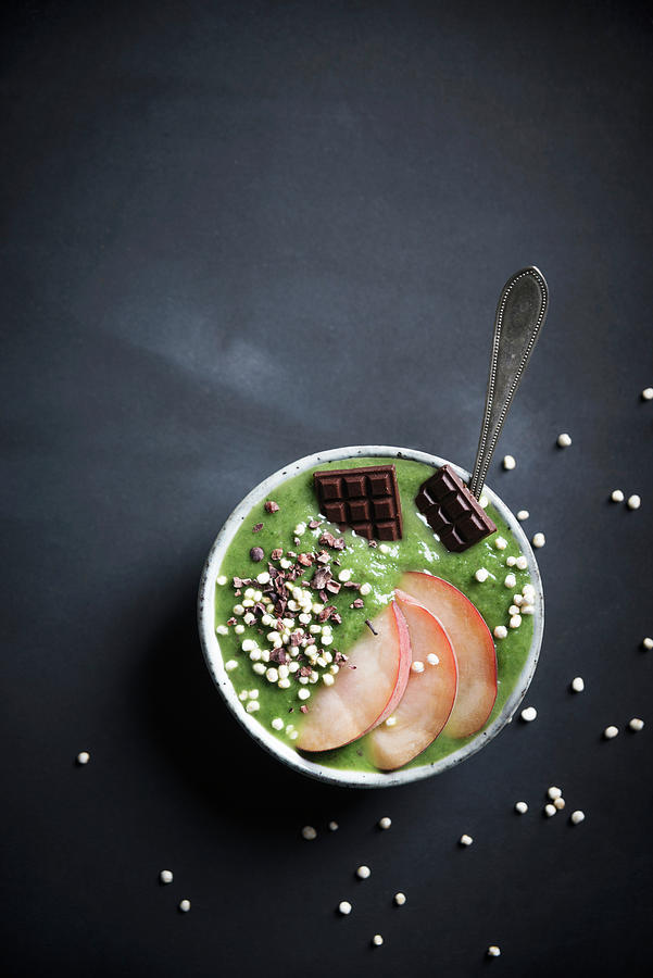 A Green Smoothie Bowl With Peaches, Quinoa Pops, Cacao Nibs And Chocolate Photograph by Kati Neudert