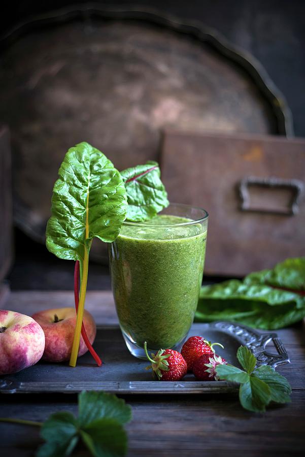 A Green Smoothie Made Of Chard, Strawberries And Peaches Photograph by Kati Neudert