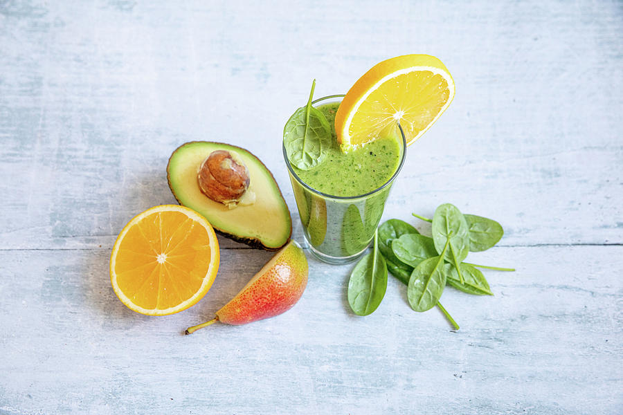 A Green Smoothie With Avocado, Spinach, Orange And Pears Photograph by Claudia Timmann