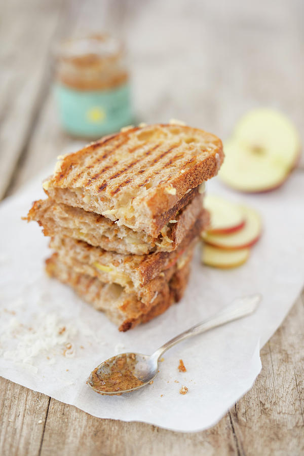 A Grilled Cheese Sandwich Made With Onion Bread, Caramel Mustard And Apples On Parchment Paper new York Photograph by Jan Wischnewski