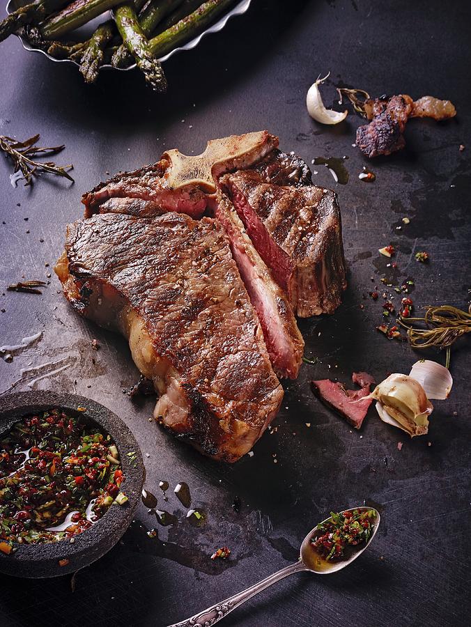 A Grilled, Dry-aged T-bone Steak With Chimichurri Photograph by Kai Stiepel