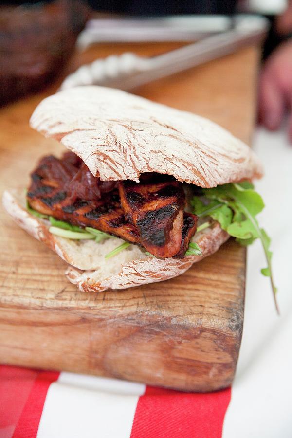 A Grilled Meat Sandwich On A Wooden Board Photograph by Claudia Timmann