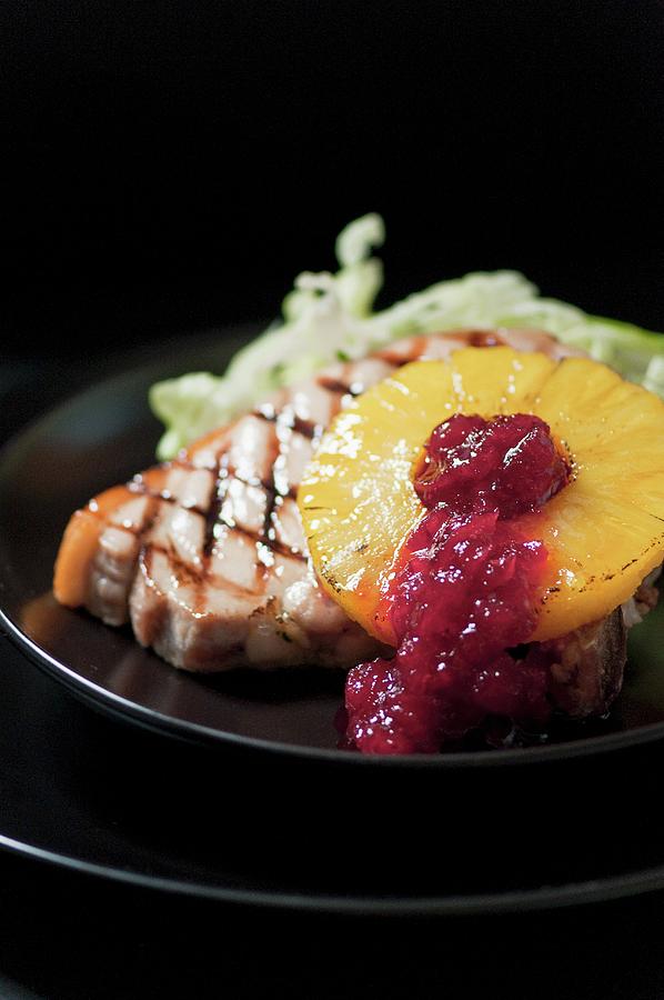 A Grilled Pork Chop With Grilled Pineapple, Lettuce And Cranberry Jam Photograph by Tomasz Jakusz