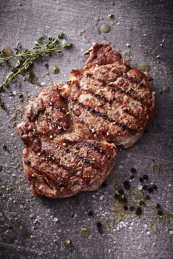 A Grilled Rib-eye Steak With Thyme, Salt And Pepper Photograph by Maximilian Carlo Schmidt