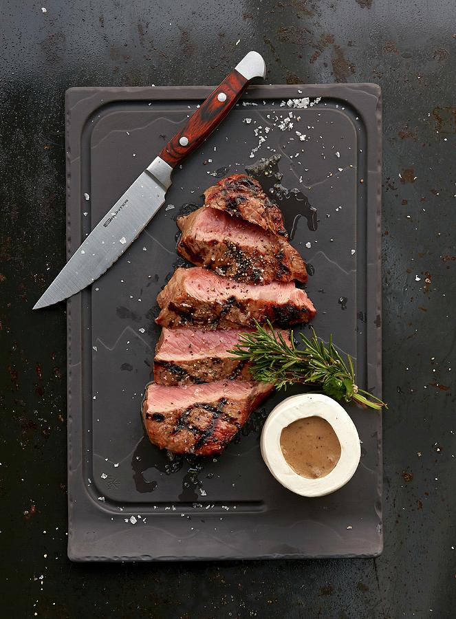 A Grilled Ribeye Steak With Sauce Photograph by Robbert Koene