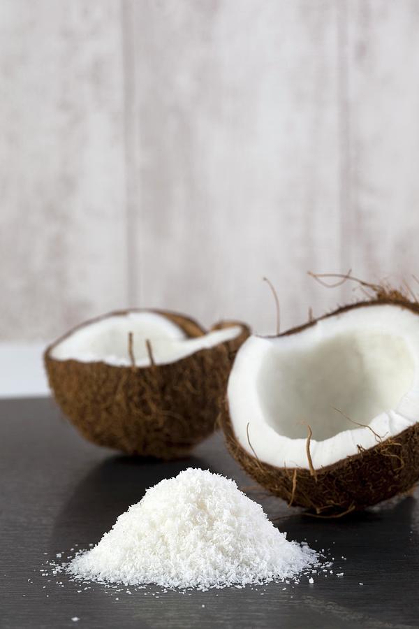 A Half Coconut With Grated Coconut Photograph by Lydie Besancon