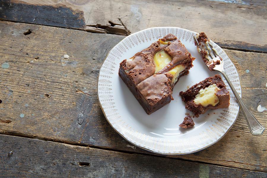 A Half-eaten Chocolate And Vanilla Brownie On A Plate With A Fork Photograph by Andr Ainsworth