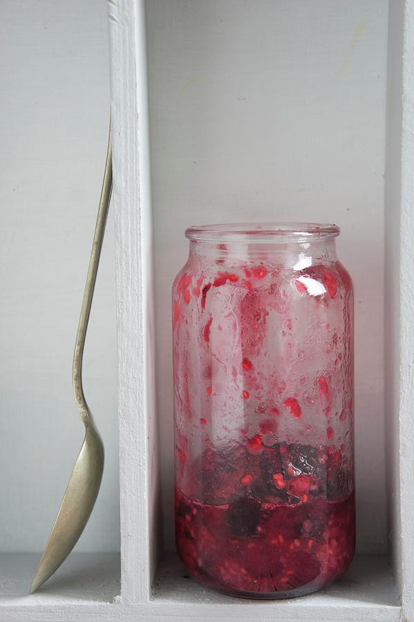 A Half Full Jar Of Raspberry And Cranberry Jam Photograph by Martina Schindler