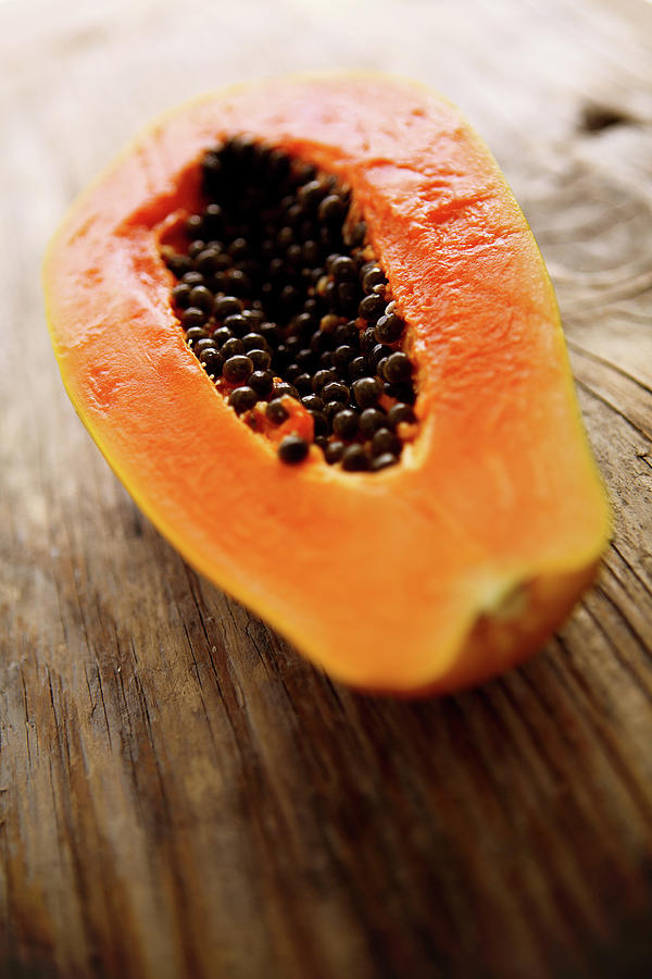 A Halved Fresh Papaya On A Wooden Photograph by Chang