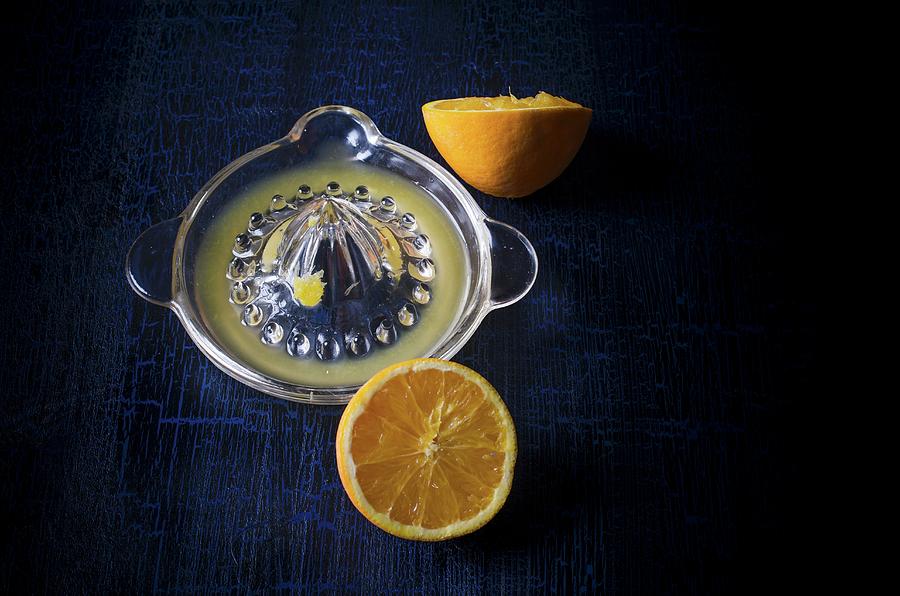 A Halved Orange With A Juice Press On A Dark Background Photograph by Nick Sida