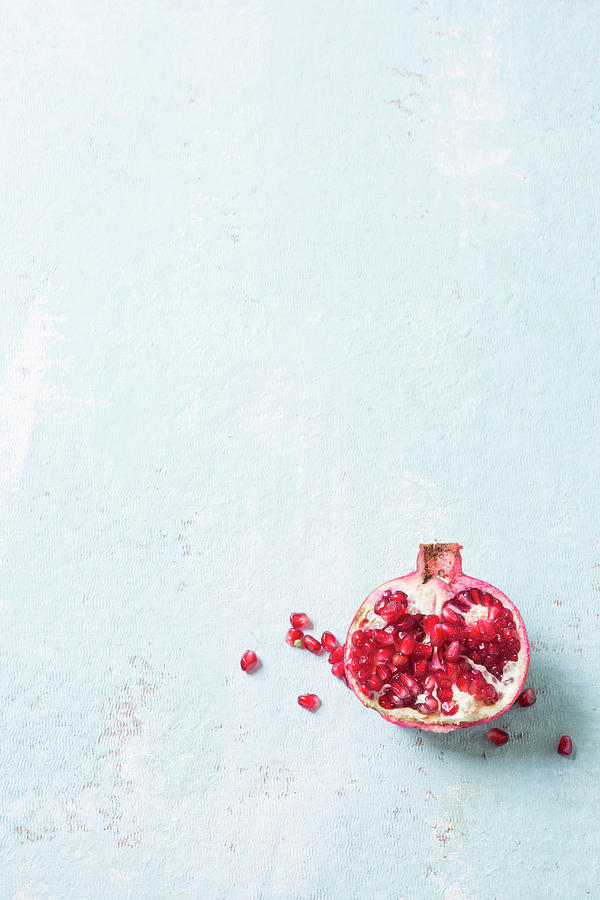 A Halved Pomegranate On A White Surface Photograph by Great Stock!