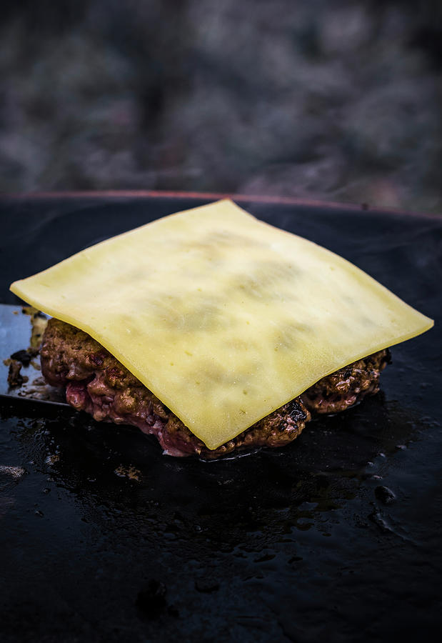 A Hamburger Patty Topped With Cheese In A Grill Pan Photograph by M. Nlke