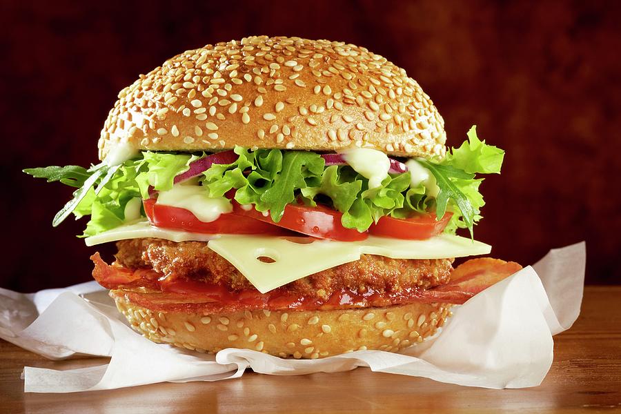 A Hamburger With Bacon, Cheese And Lettuce Photograph by Raben, Sven C.