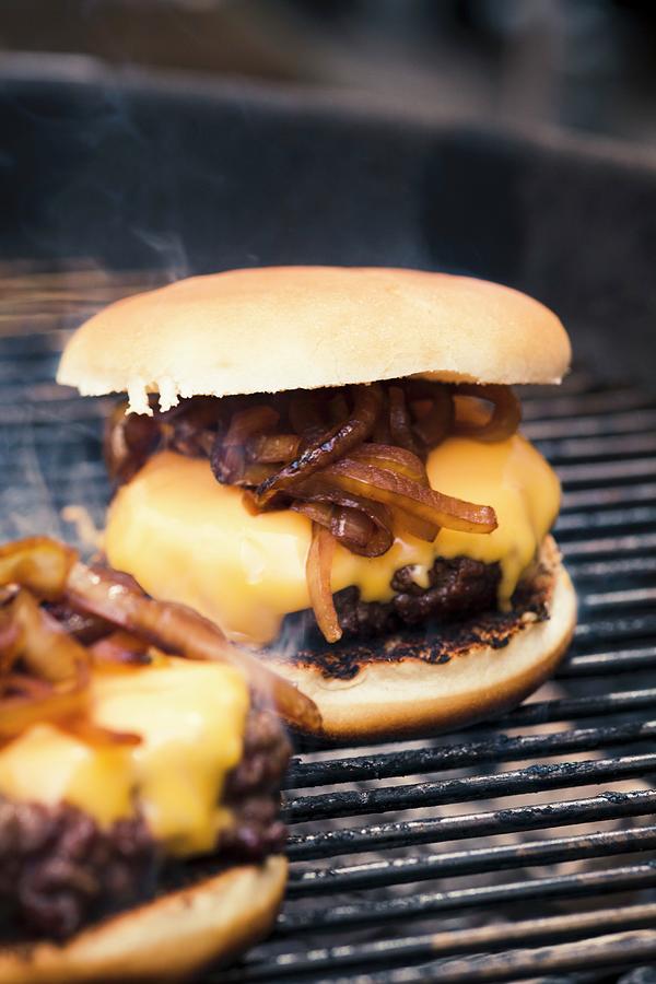 A Hamburger With Cheese And Toasted Onions On A Grill Photograph by Eising Studio