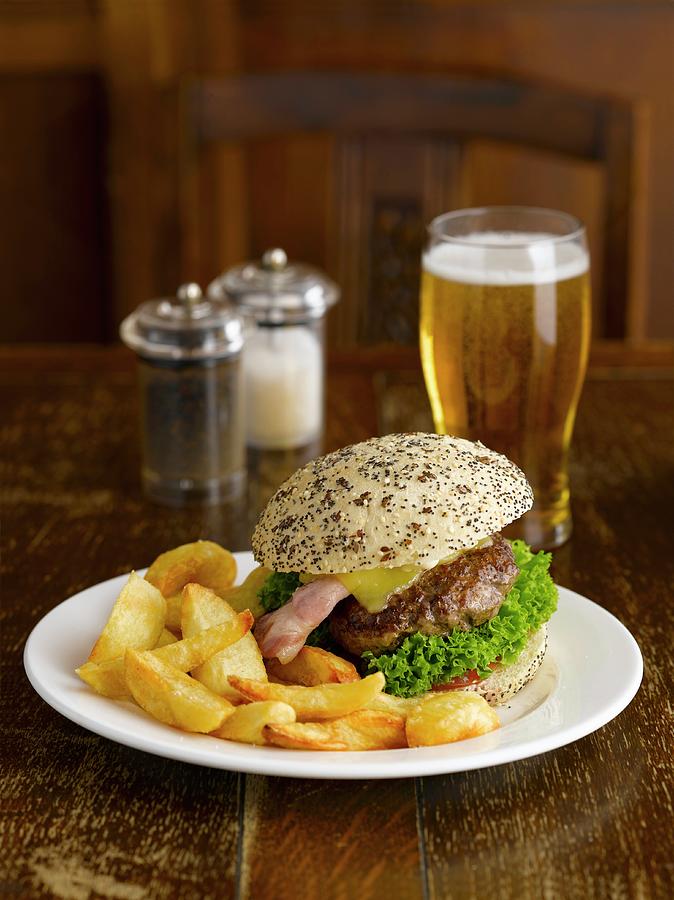 A Hamburger With Chips And Beer In A Pub Photograph by Michael Hart
