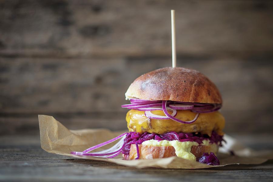 A Hamburger With Red Cabbage, Cheddar And Red Onions Photograph by Jan Wischnewski