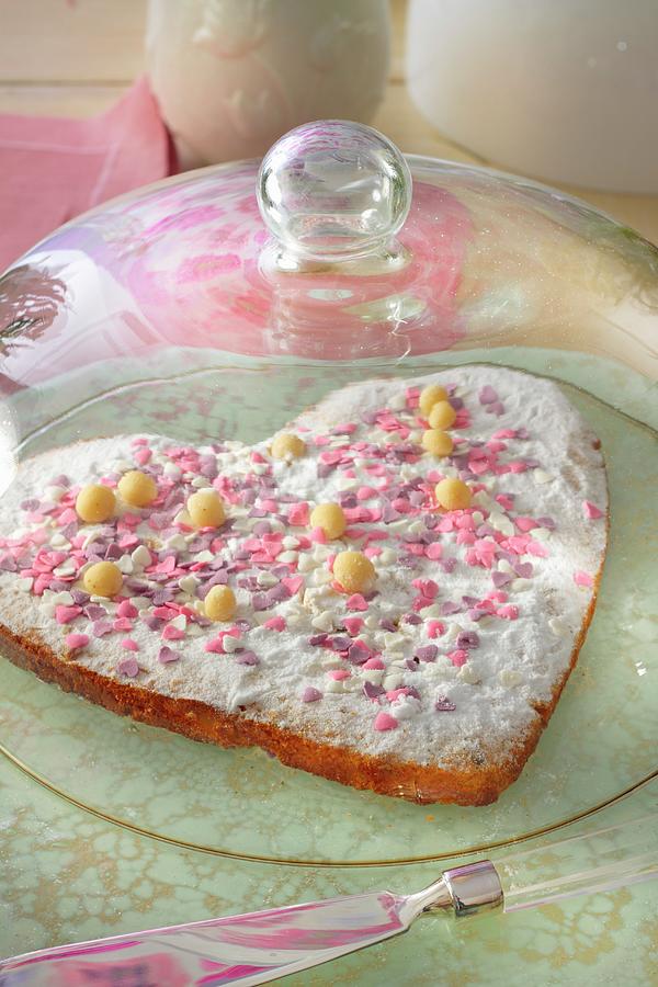 A Heart-shaped Cake Decorated With Pink Sugar Hearts Under A Glass Cloche Photograph by Radoslaw Wojnar