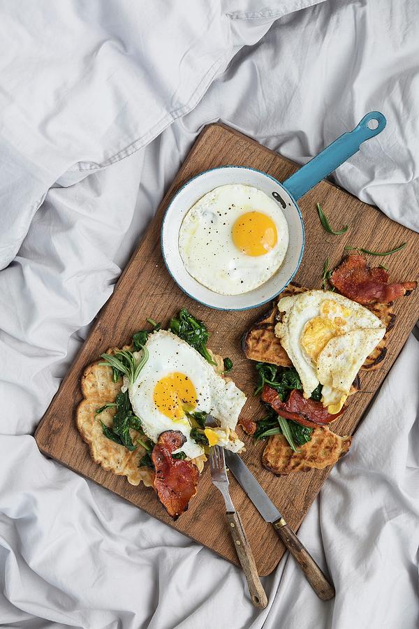 A Hearty Breakfast With Fresh Waffles, Spinach, Bacon And Fried Eggs Photograph by Sarah Coghill