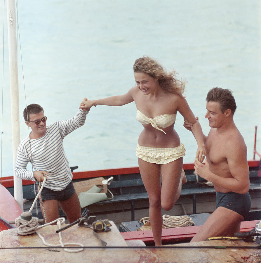 A Helping Hand Photograph by Slim Aarons
