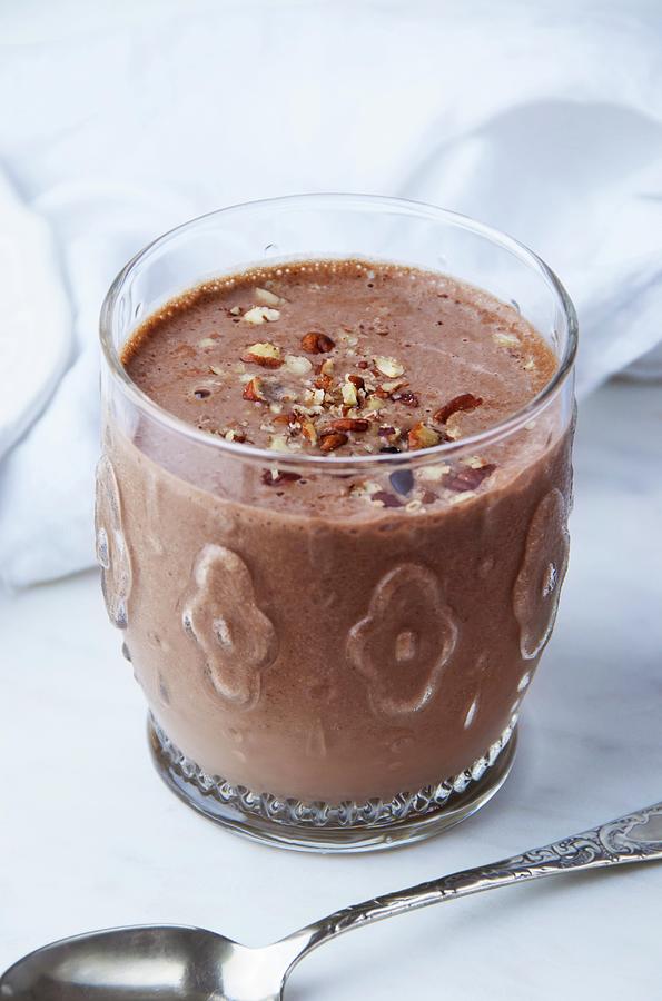 A High-protein Chocolate & Almond Smoothie In A Glass, Topped With Chopped Nuts Photograph by Jennifer Blume