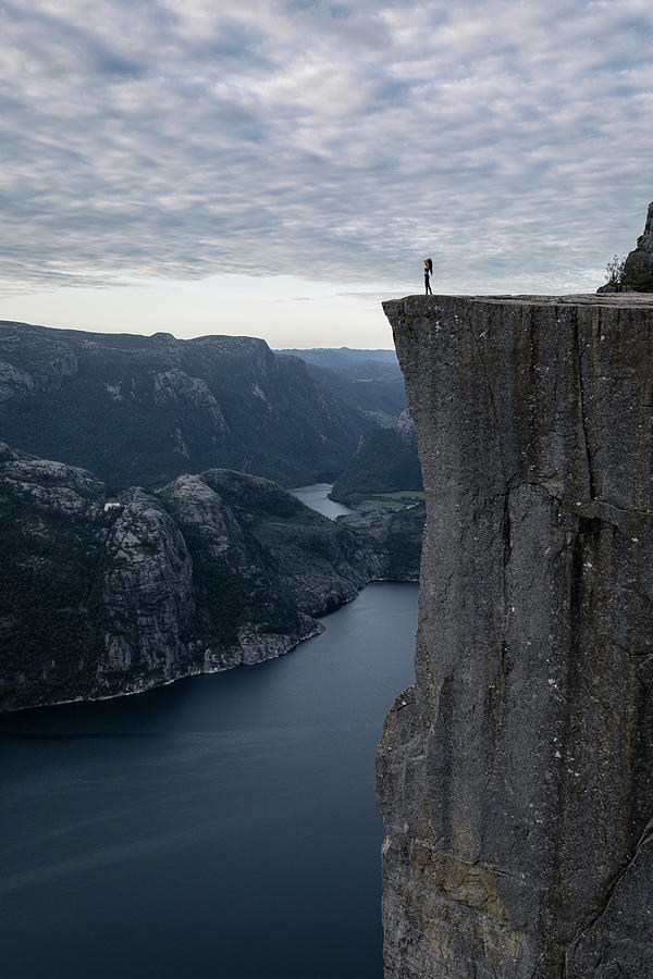 A Hiker On The Edge At Pulpit Rock (preikestolen) In Norway Photograph ...