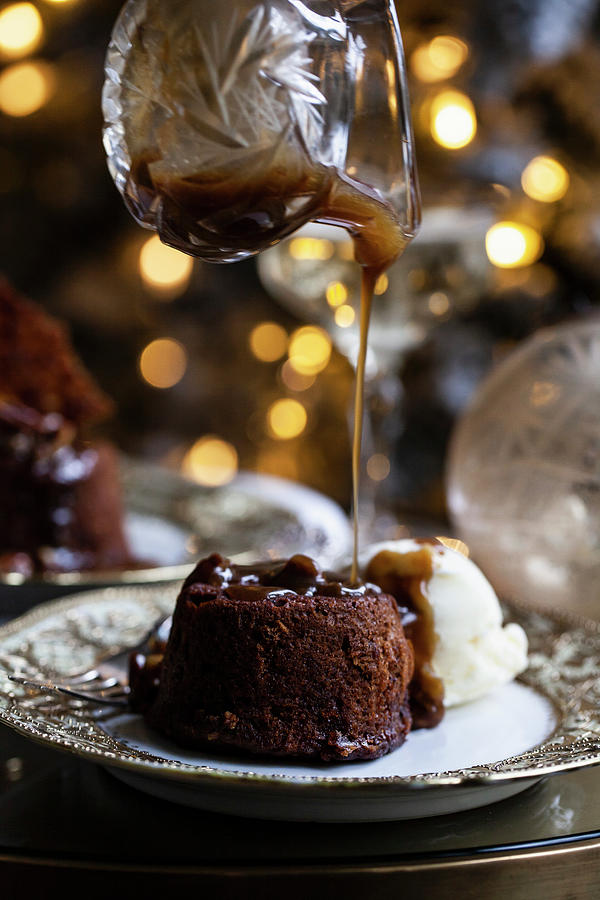 A Holiday Table Set Up With Sticky Toffee Pudding With Pecan Caramel Sauce Being Drizzled On Top Photograph by Ryla Campbell