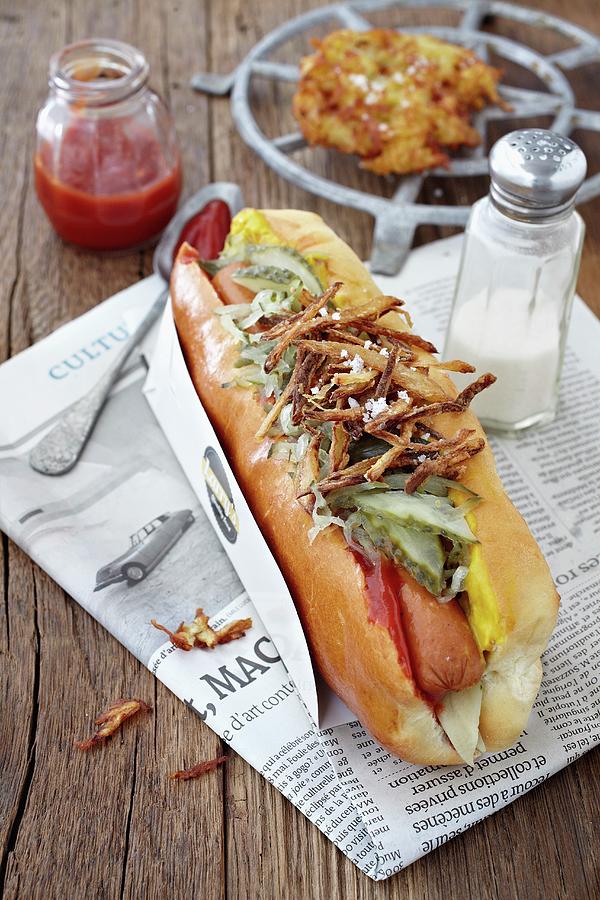 A Hot Dog With Gherkins, Onions, Ketchup And Honey Mustard Photograph by Alessandra Pizzi