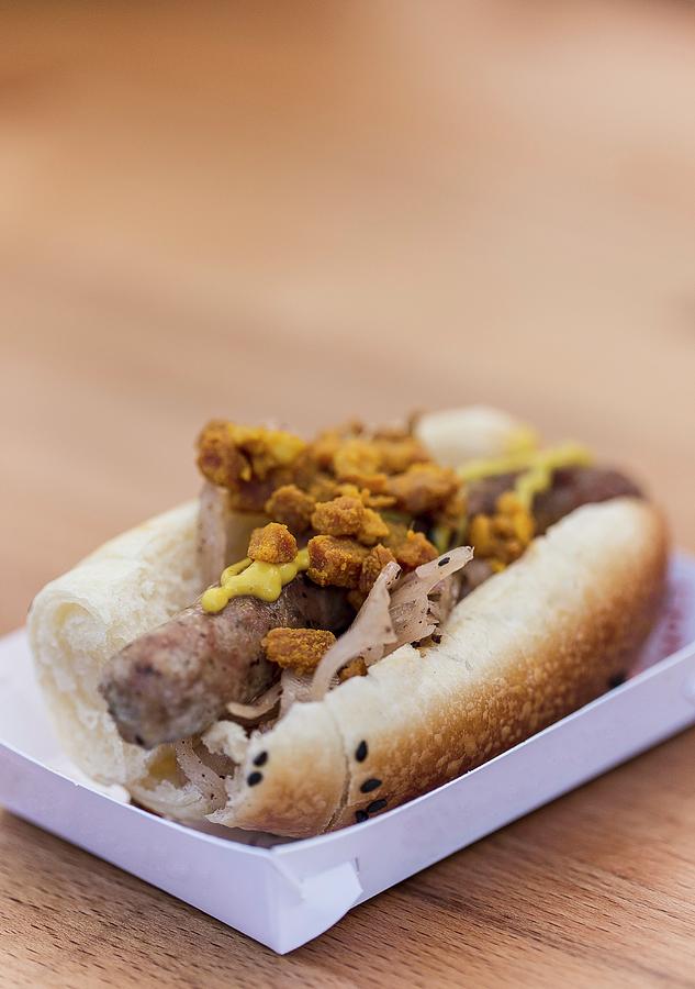 A Hot Dog With Sausage, Sauerkraut And Bacon Bits At A Fast Food Stand Photograph by Adel Bekefi