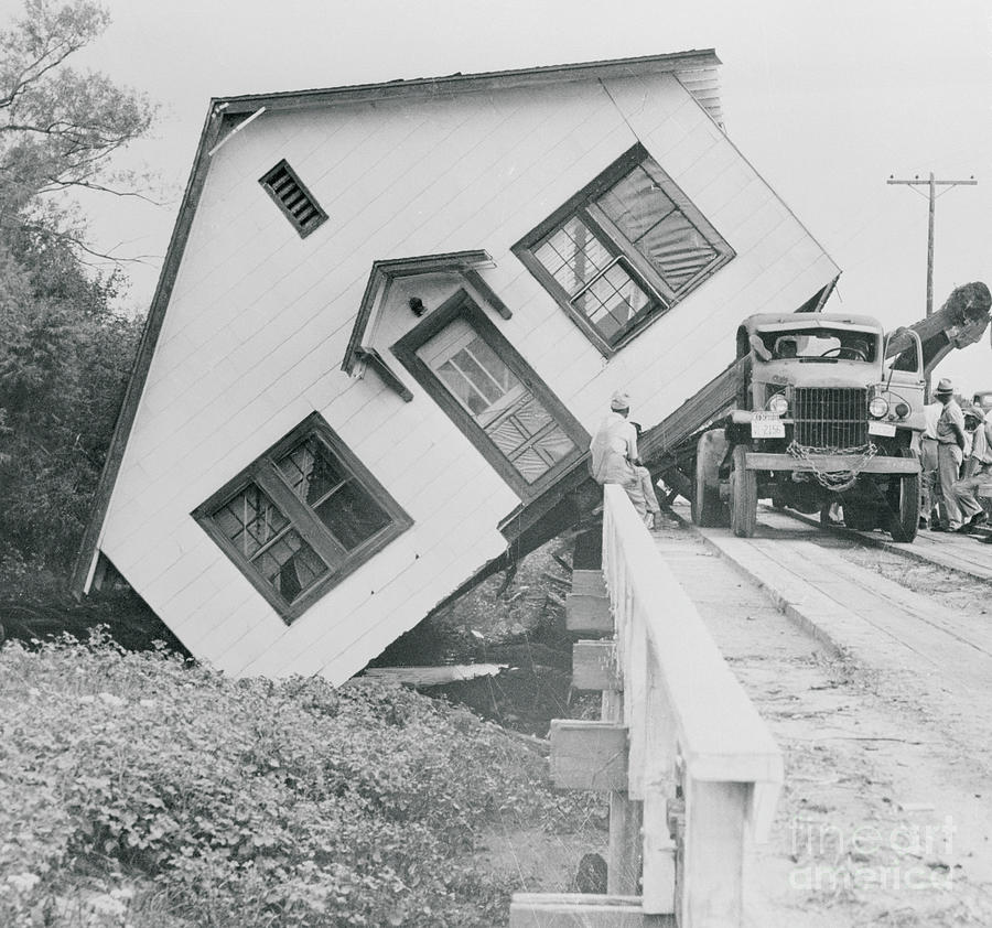A House Falling Off A Bridge Photograph by Bettmann