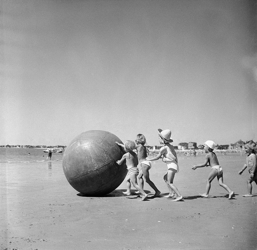A Huge Ball On The Beach Photograph by Keystone-france