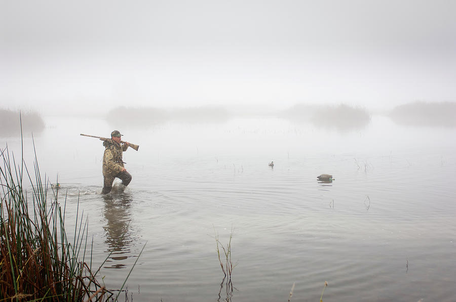 A Hunter In The Water Wearing Photograph by Laura Ciapponi / Design Pics