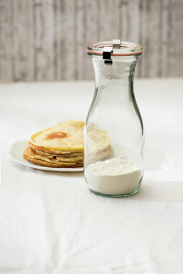 A Jar Containing The Dry Ingredient Mix For Making Pancakes And A Plate Of Cooked Pancakes Photograph by Sauer, Brigitte