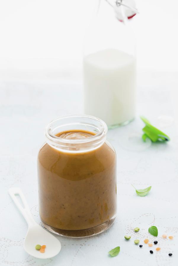 A Jar Of Baby Lentil Pure With A Bottle Of Milk In The Background Photograph by Au Petit Gout Photography Llc