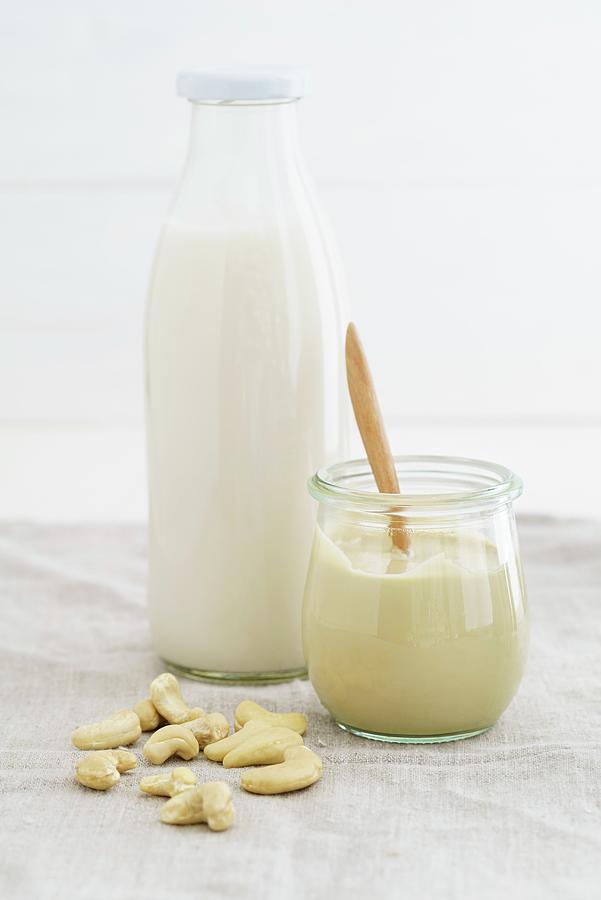 A Jar Of Cashew Nut Mousse And Cashew Nut Milk In A Glass Bottle Photograph by Elisabeth Clfen