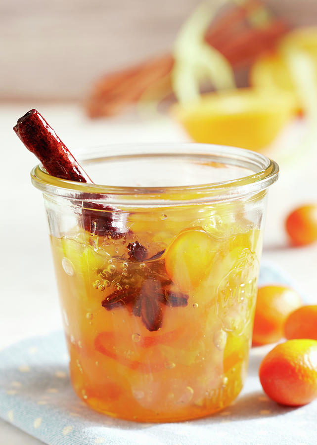 A Jar Of Exotic Spiced Jam With Kumquats, Star Fruit, Star Anise And Cinnamon Photograph by Teubner Foodfoto