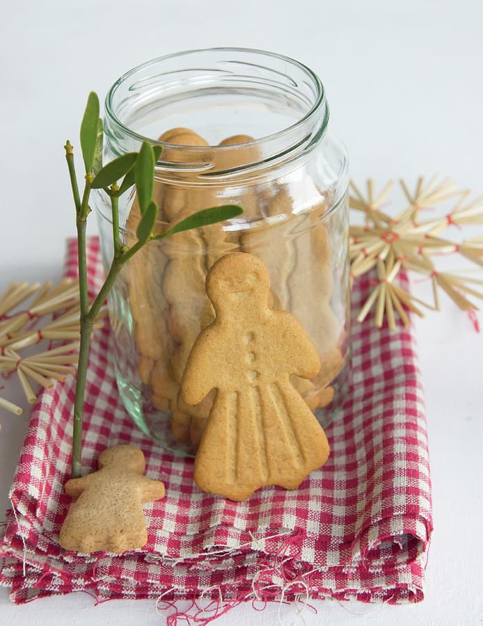 A Jar Of Gingerbread On A Cloth With Mistletoe And Straw Stars Photograph by Martina Schindler